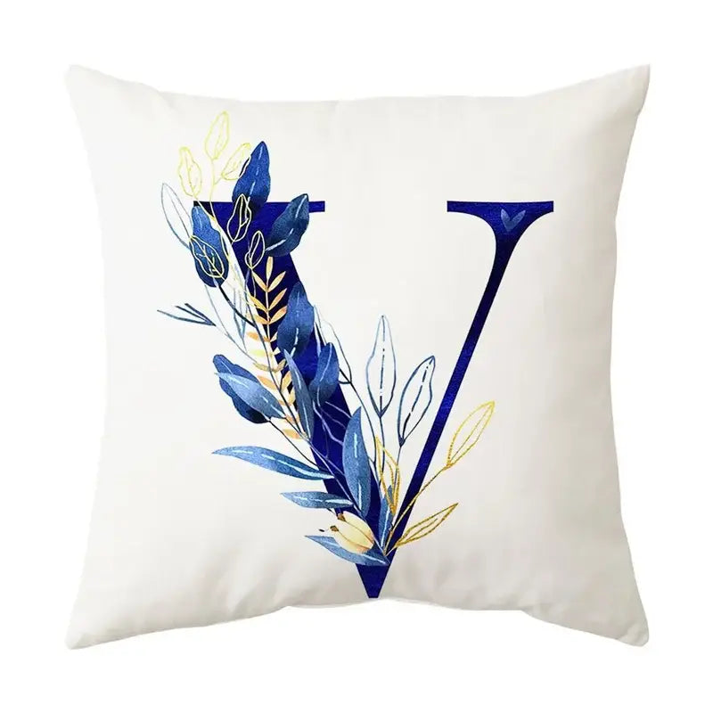 White throw pillow with a stylized navy and gold alphabet flower letter v for decorbites blue alphabet decor