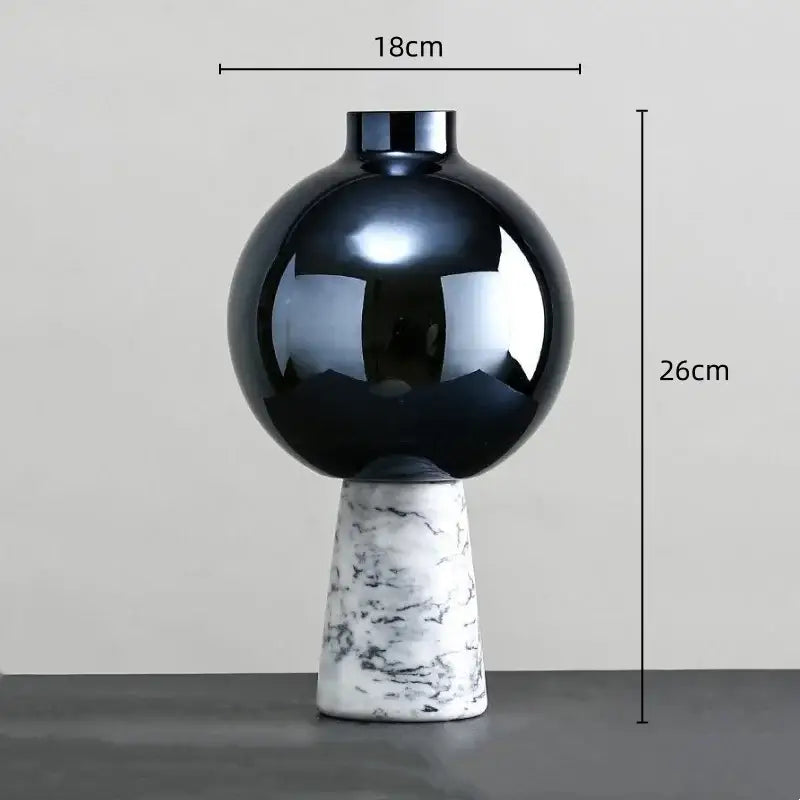 A sleek glossy black ceramic vase with a marble base featuring geometric circle star design for living room decor