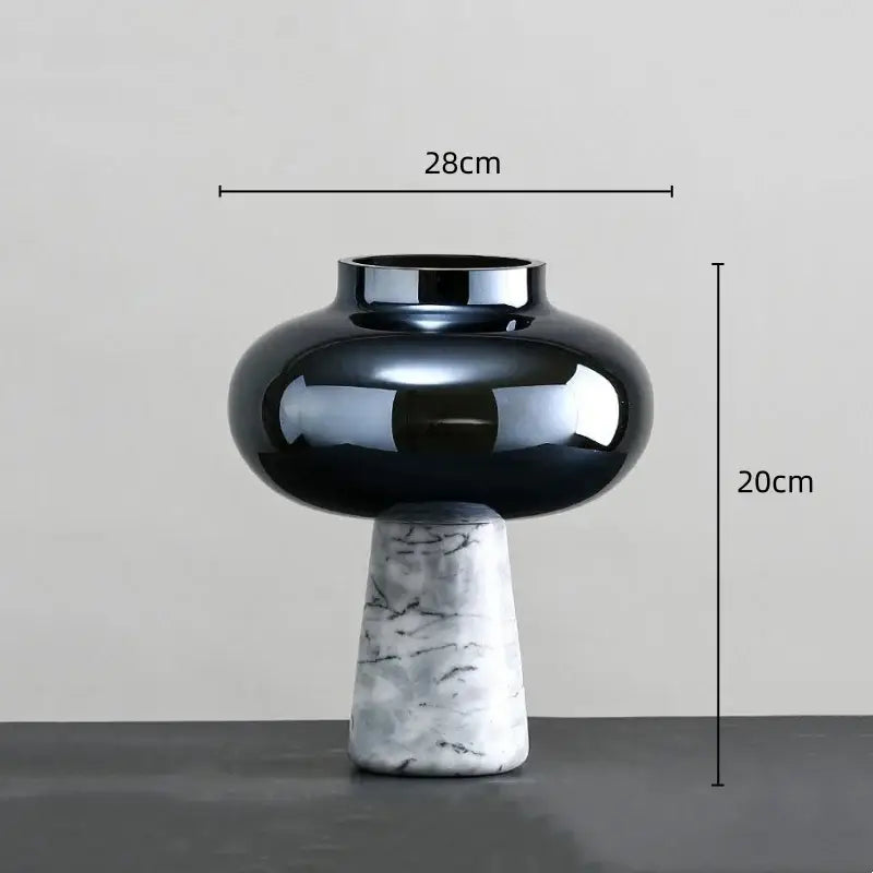 A sleek black glass geometric circle star vase with a marble-patterned base for living room decor