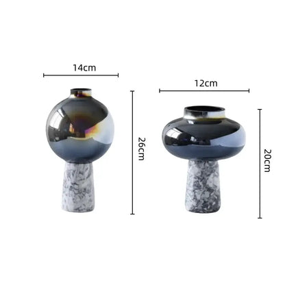 Two modern glass vases with iridescent navy blue geometric circle star finishes on white marble bases for living room decor