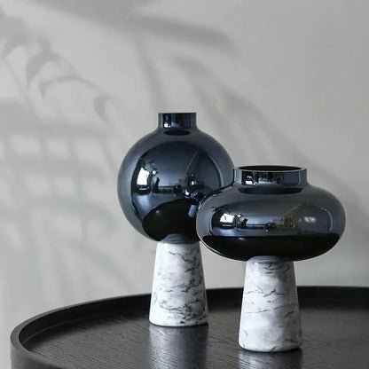 Two glossy black glass vases with white marble bases featuring geometric circle star design for living room decor