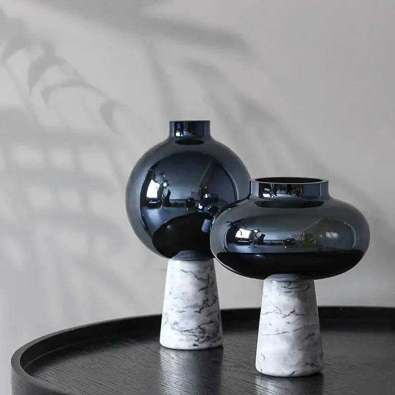 Two glossy black glass vases with white marble bases featuring geometric circle star design for living room decor