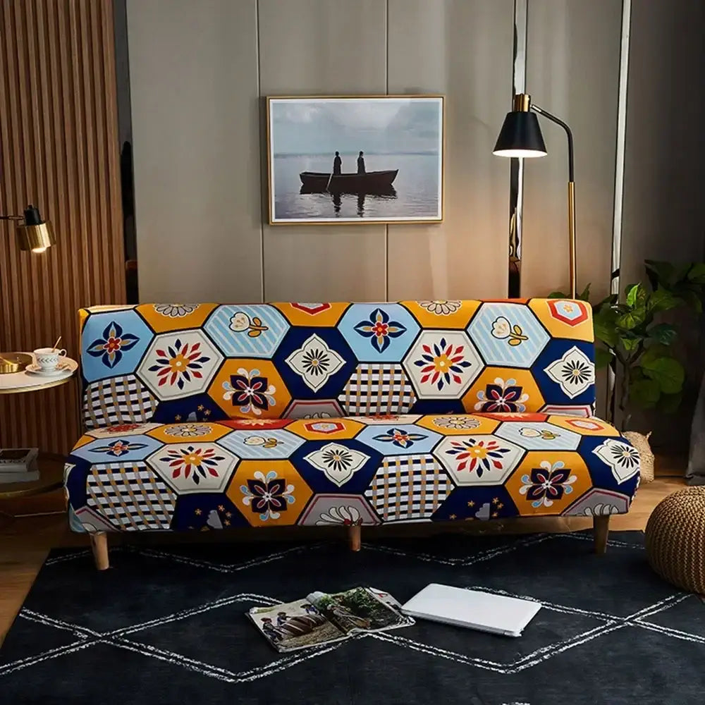 A vibrant bohemian mandala futon sofa cover in navy blue gold yellow blue and orange with floral and geometric designs