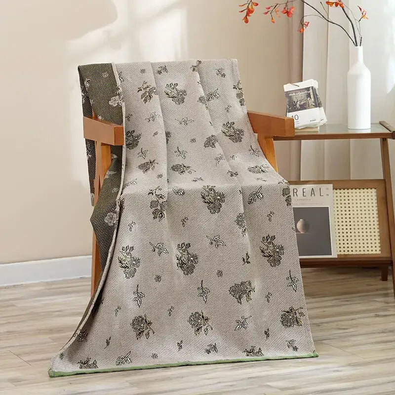A light gray woven cotton gauze blanket with black floral pattern displayed with navy blue gold hibiscus cat bath towel decorbites cat bath