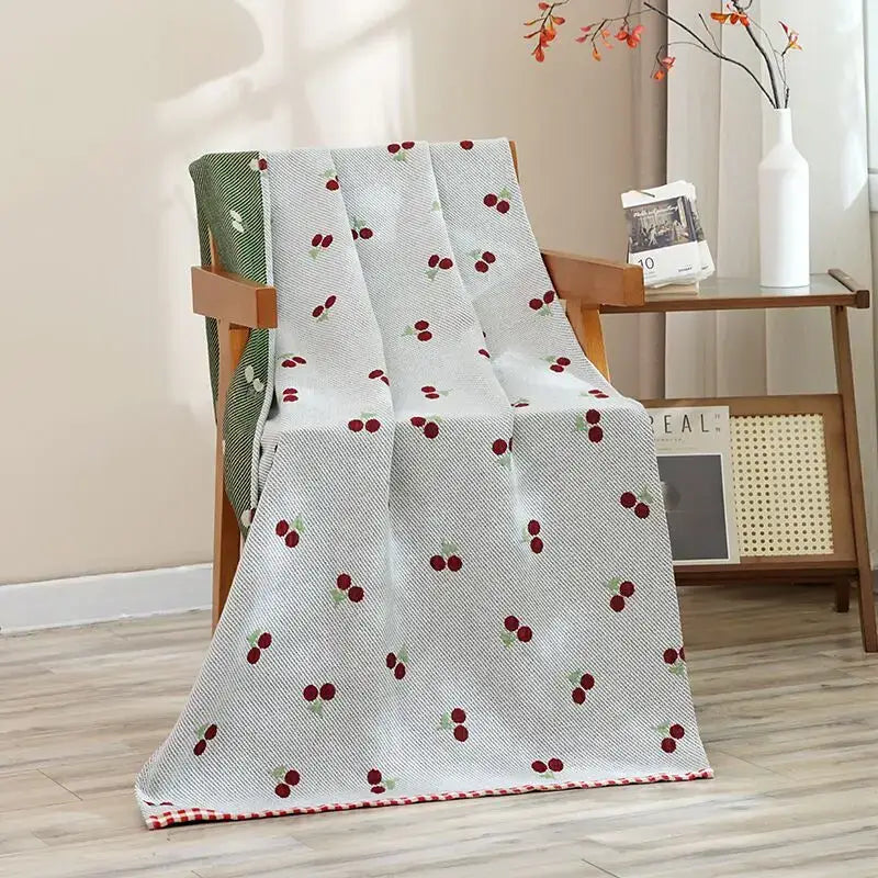 A light gray woven bath towel with embroidered red cherries and checkered border for decorbites cat bath use