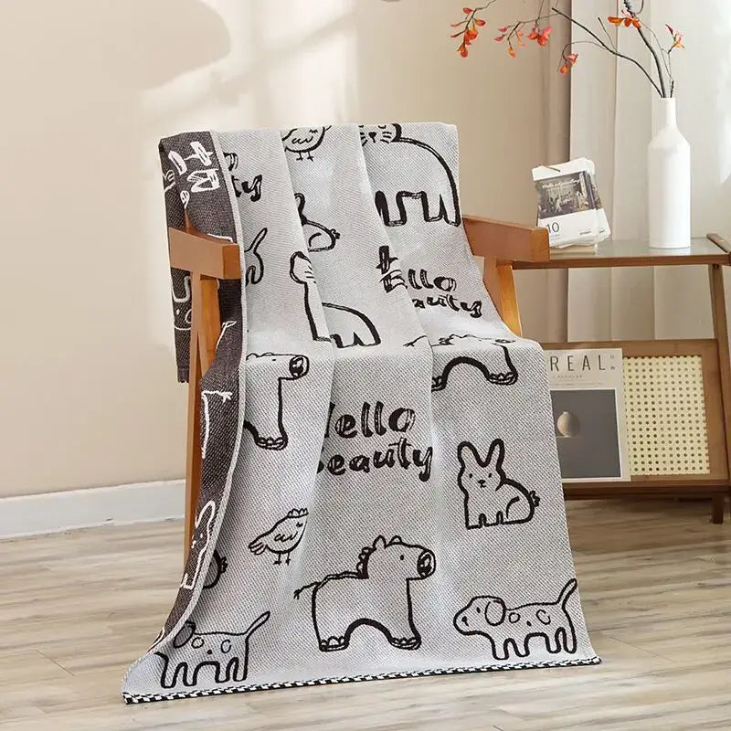 A soft gray knitted throw with black animal line art and hello beauty phrase paired with a navy blue gold hibiscus cat bath towel decorbites cat bath towel
