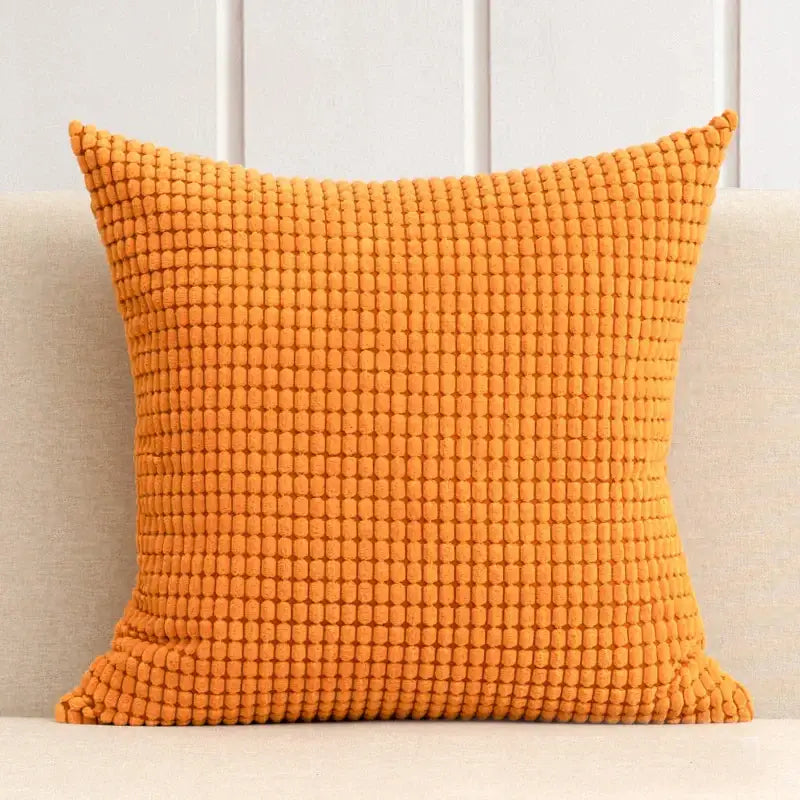 Vibrant orange textured throw pillow with woven raised dot pattern as part of decorbites corduroy corn grain cushion cover set