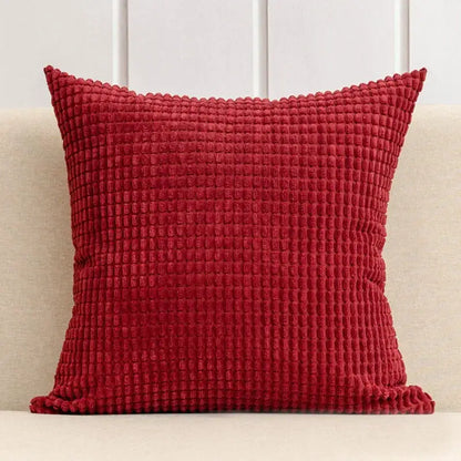 Red corduroy cushion cover with textured waffle pattern from decorbites corn grain living room set