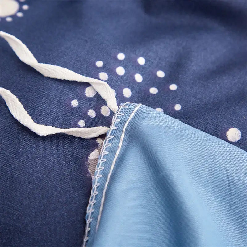 Navy space planet bedding set featuring navy blue fabric with white polka dots and light blue satin trim decorbites cosmos luminous