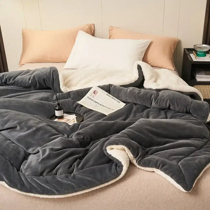 A plush dark gray double layer queen blanket with soft white sherpa lining for cozy bedroom comfort