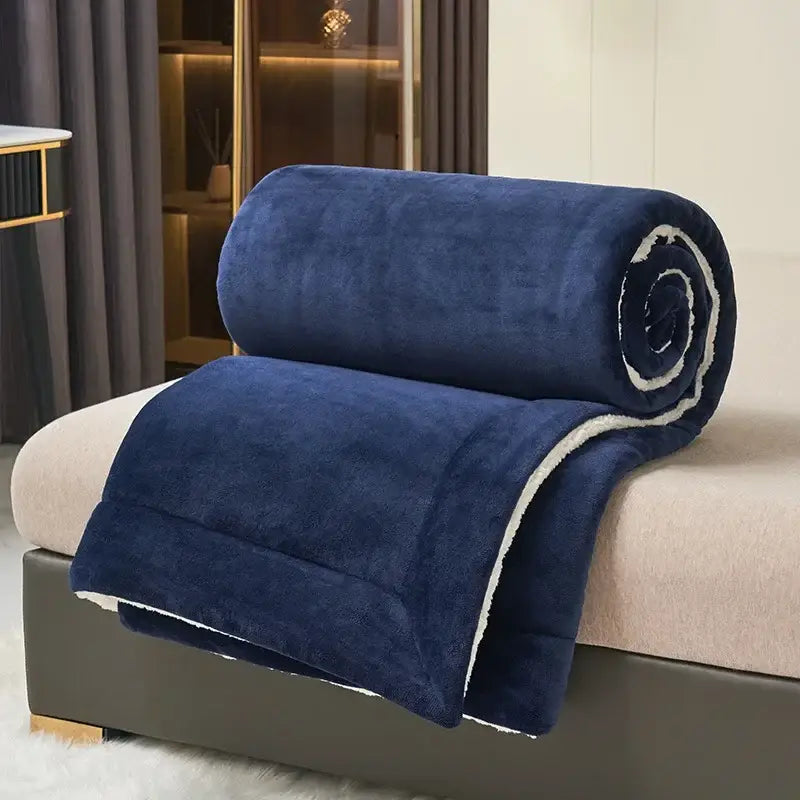 A plush navy blue and white sherpa double layer queen blanket with soft fuzzy exterior and cozy sherpa lining