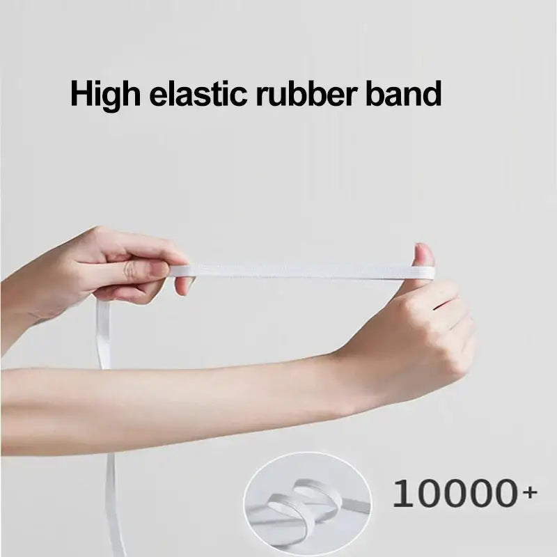 White high elastic rubber band on the edge of a neutral microfiber double bed elastic fitted sheet for secure fit