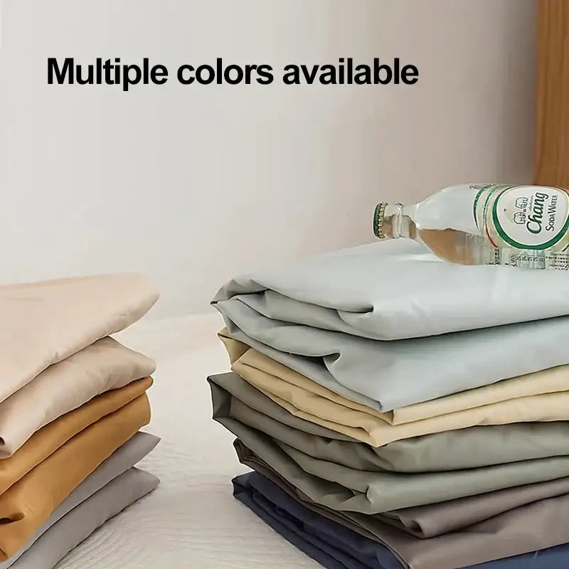 Stack of neatly folded neutral-toned microfiber fabric items including double bed elastic fitted sheet bedroom cover