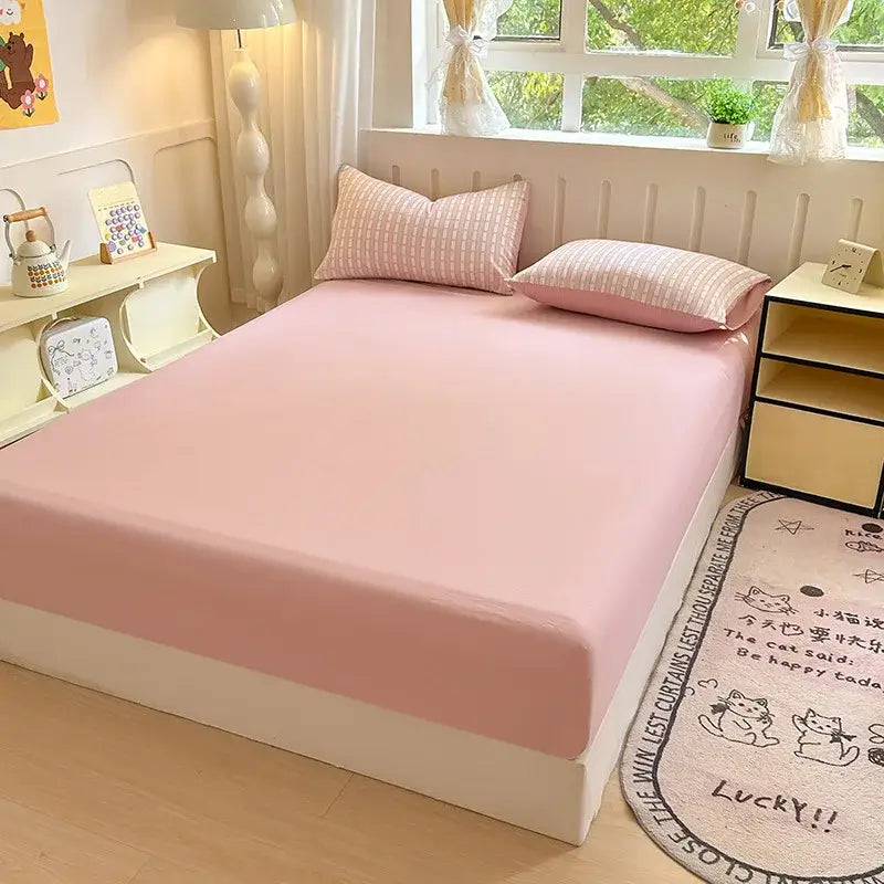 Pink microfiber bed elastic fitted sheet with smooth stretchy fabric snugly covering a double bed mattress