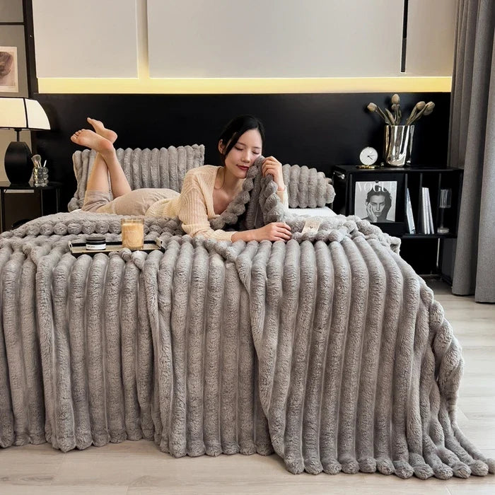 A plush gray ribbed knit throw blanket made of soft coral fleece and bamboo fiber for autumn warmth and comfort