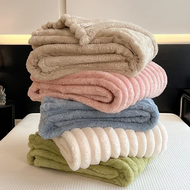 Stack of pastel-colored new artificial rabbit plush autumn warm blankets in soft coral fleece with bamboo fiber blend