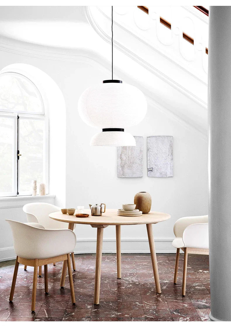 White paper rice lantern light with black accents hanging above wooden dining table for dining room shop hanging light