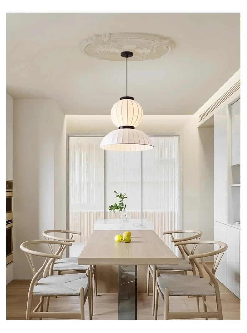 Noguchi pendant light with dual-tiered pleated white rice paper shade hanging from black rod for dining room shop hanging light