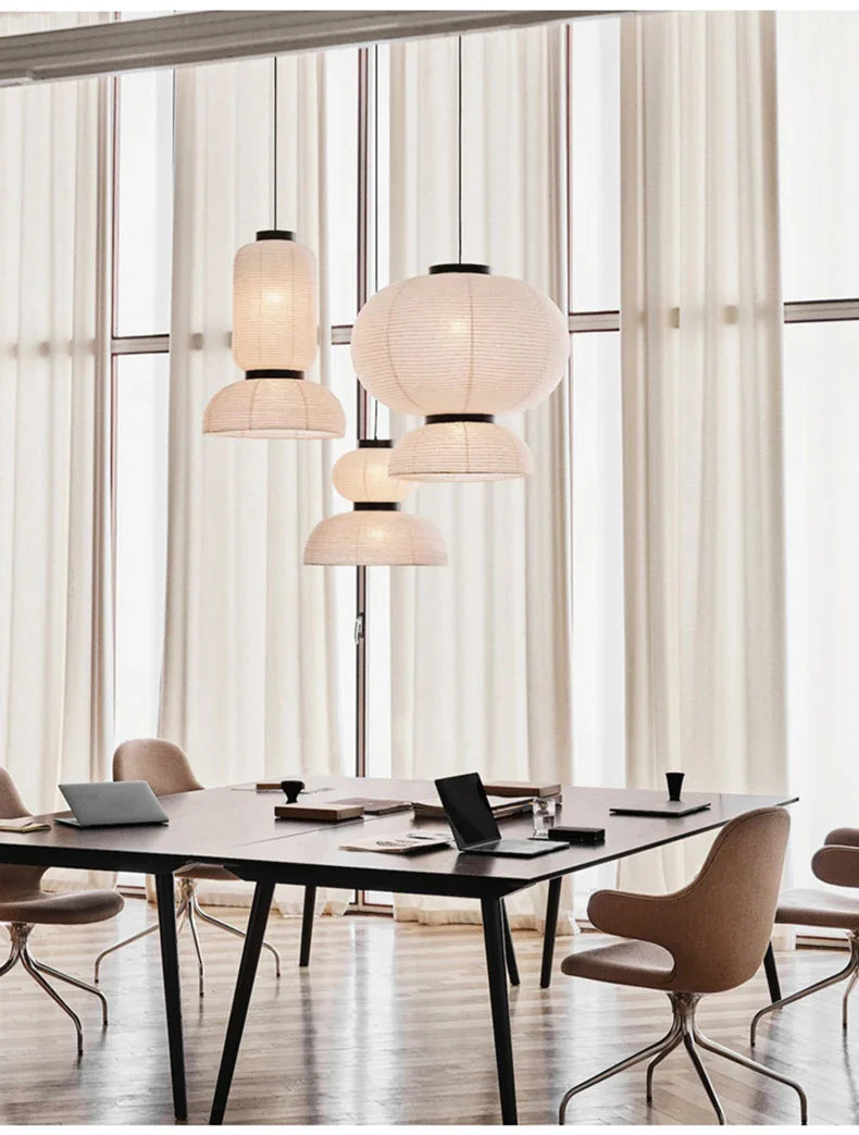 Cream-colored noguchi pendant lantern light with black metal accents hangs from ceiling for dining room shop hanging light