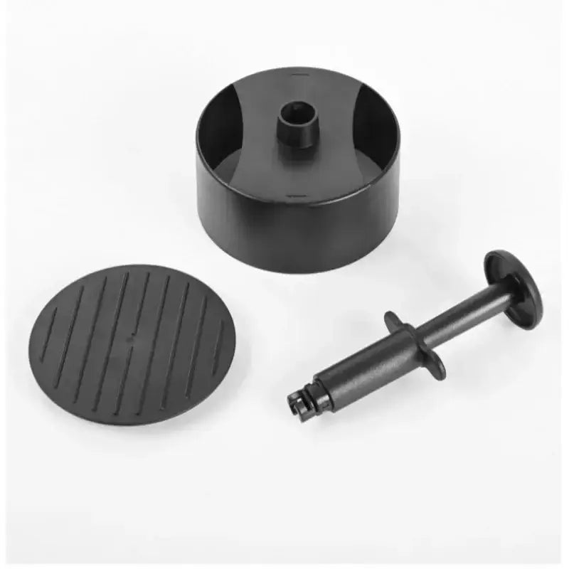 Black plastic non-stick hamburger meat press set with circular mold textured base plate and syringe-style plunger