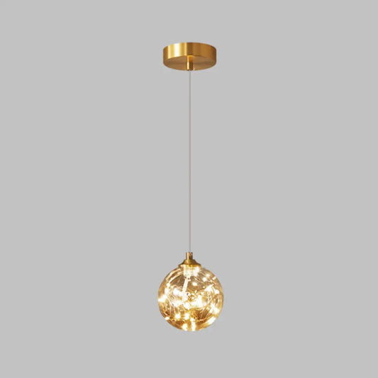 Nordic Amber Glass LED Pendant Lamp with Brass Finish and Starry Design for Bedroom