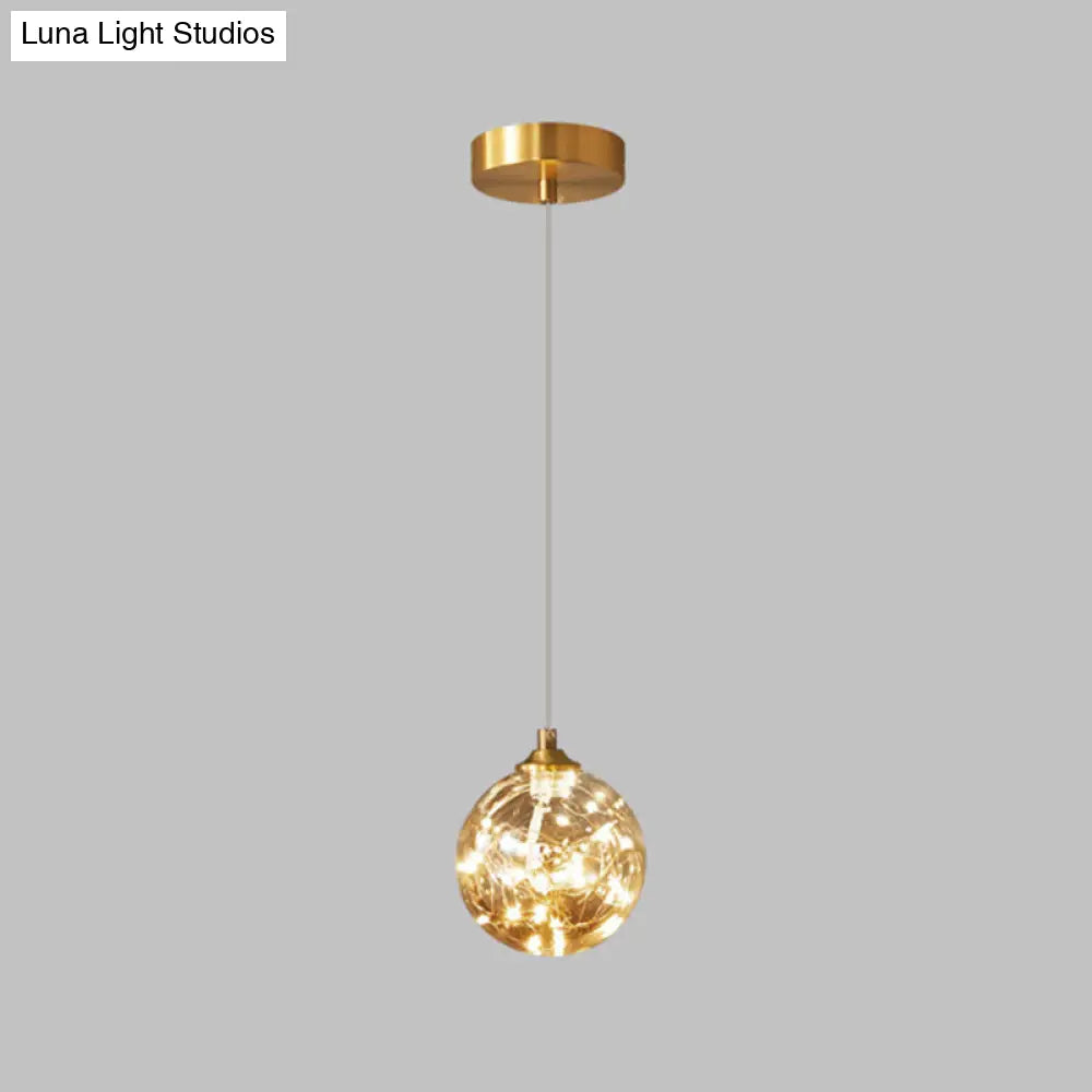 Nordic Amber Glass LED Pendant Lamp with Brass Finish and Starry Design for Bedroom