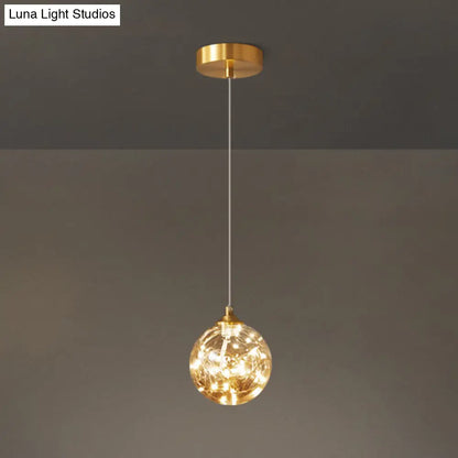 Nordic Amber Glass LED Pendant Lamp with Brass Finish and Starry Design for Bedroom