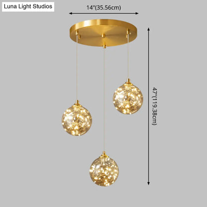 Nordic Amber Glass LED Pendant Lamp with Brass Finish and Starry Design for Bedroom