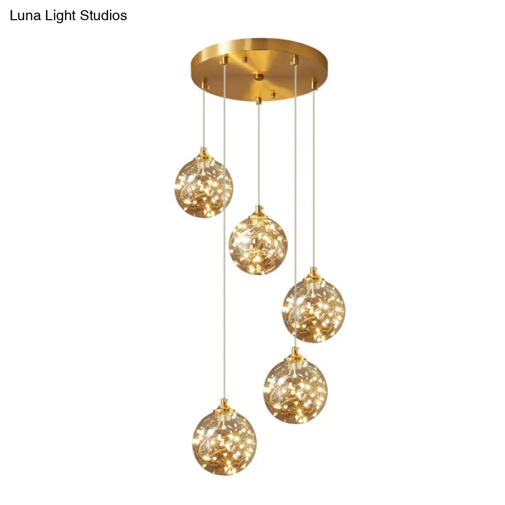 Nordic Amber Glass LED Pendant Lamp with Brass Finish and Starry Design for Bedroom