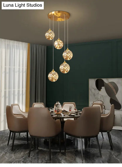 Nordic Amber Glass LED Pendant Lamp with Brass Finish and Starry Design for Bedroom