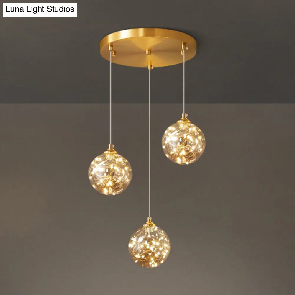 Nordic Amber Glass LED Pendant Lamp with Brass Finish and Starry Design for Bedroom