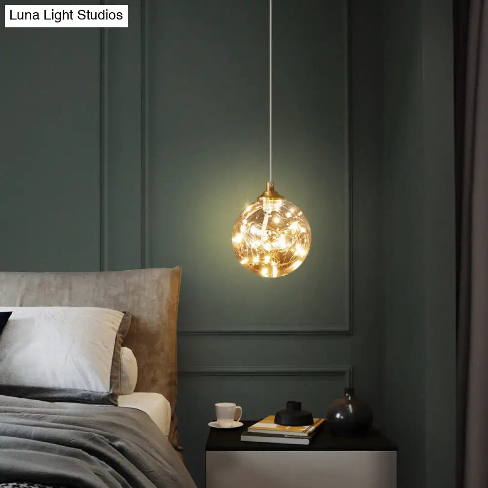 Nordic Amber Glass LED Pendant Lamp with Brass Finish and Starry Design for Bedroom