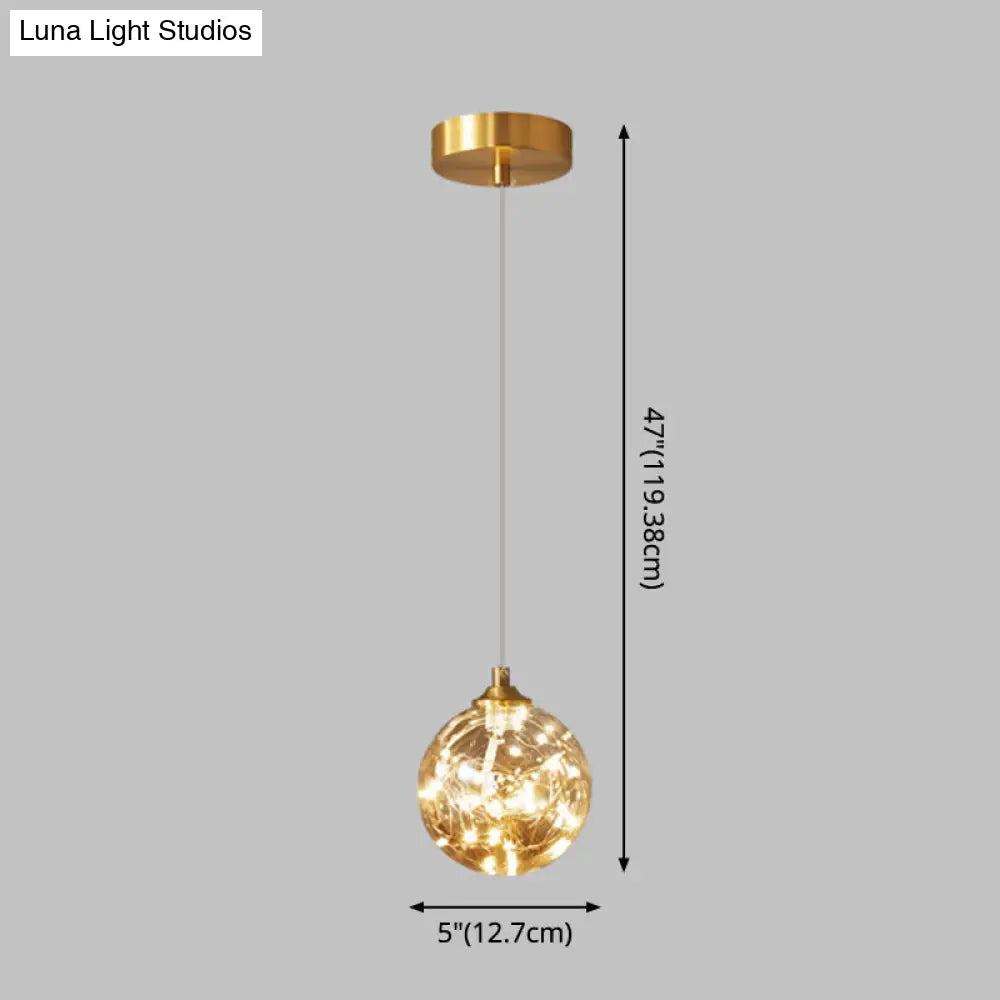 Nordic Amber Glass LED Pendant Lamp with Brass Finish and Starry Design for Bedroom