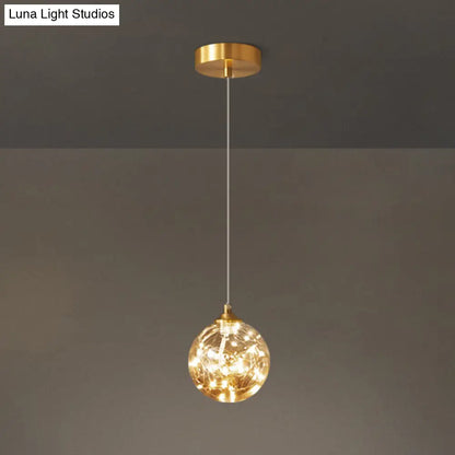 Nordic Amber Glass LED Pendant Lamp with Brass Finish and Starry Design for Bedroom