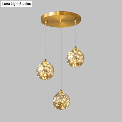 Nordic Amber Glass LED Pendant Lamp with Brass Finish and Starry Design for Bedroom