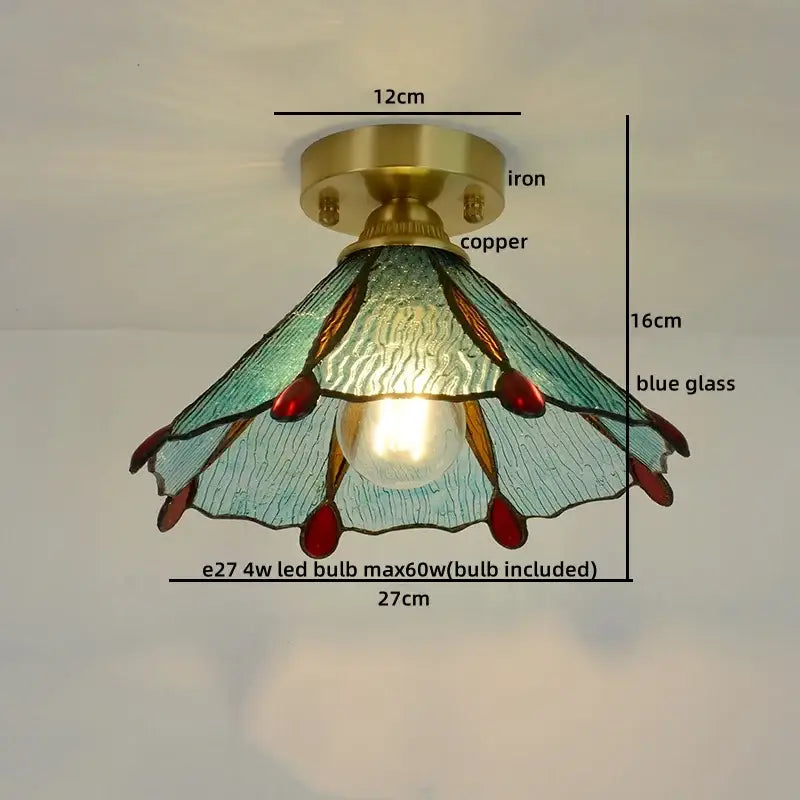 A tiffany-style copper led ceiling light with blue stained glass petals and brass base for bedroom use