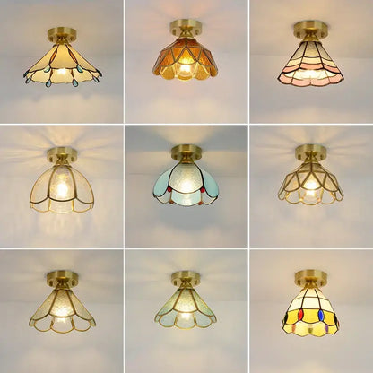 A collection of nine brass-finished glass copper led ceiling lights with amber and teal stained glass panels