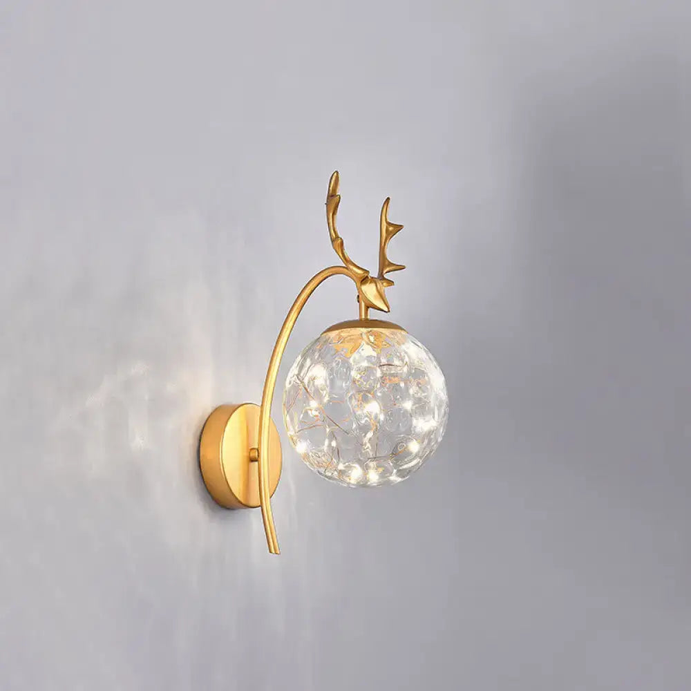 Gold-toned nordic ball wall deer-head sconce with faceted crystal globe and black antler mount for bedroom lighting