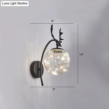 Black metal nordic ball wall mount deer head sconce with textured glass globe and warm led bedroom fairy light