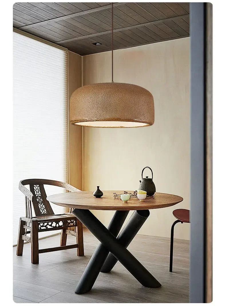Textured beige woven basket-like nordic led pendant lamp hanging above table for bar or restaurant lighting