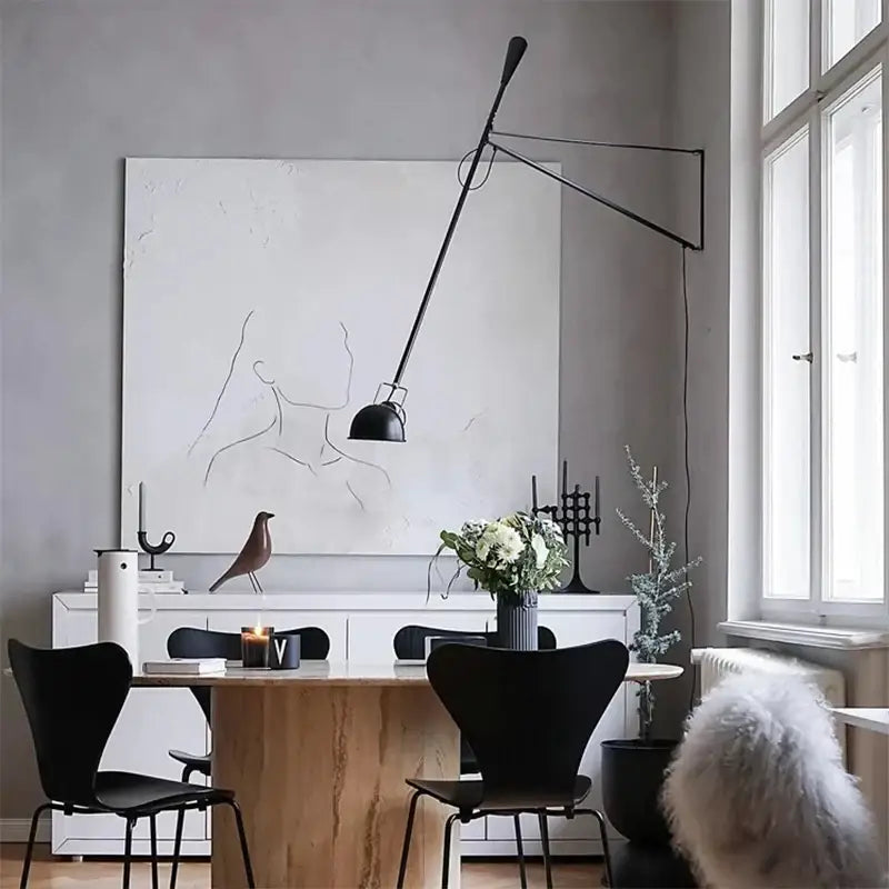 Black articulated wall lamp with adjustable long arm and matte finish designed for modern bedroom lighting