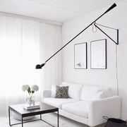 Black articulated wall lamp with adjustable long metal arms and minimalist design for bedroom lighting