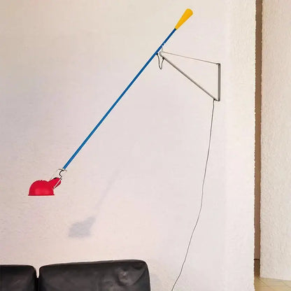 Vibrant red blue and yellow articulated wall lamp with adjustable long arm and sleek metallic bracket for bedroom use