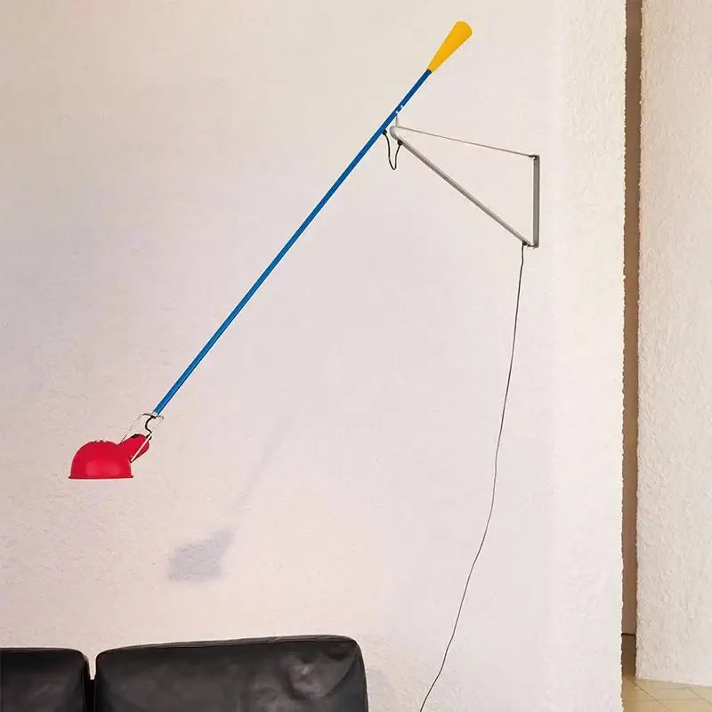 Vibrant red blue and yellow articulated wall lamp with adjustable long arm and sleek metallic bracket for bedroom use