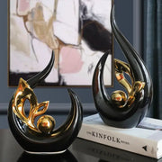 Nordic black and gold ceramic figurine with sleek curved forms and metallic accents for living room desk decor
