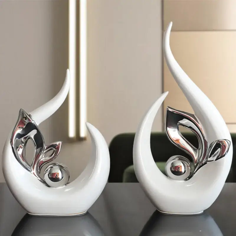 White ceramic figurine with sleek curves and silver leaf motif accented by reflective sphere for nordic ceramic decor