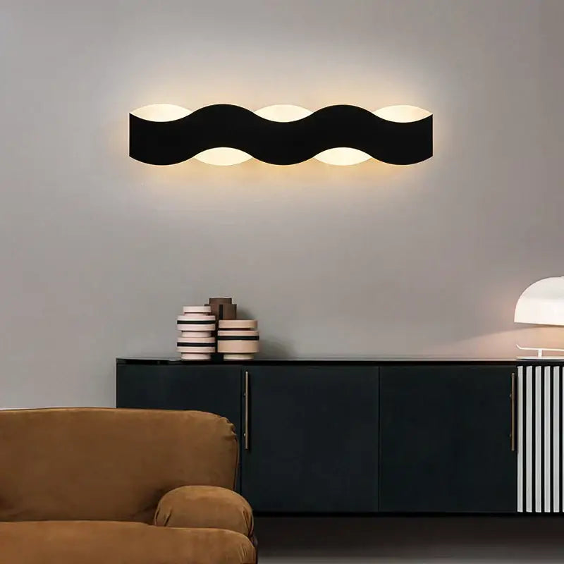 Black wavy led wave wall light with three illuminated circular bulbs ideal for bedroom sculptural decorbites led wave decor