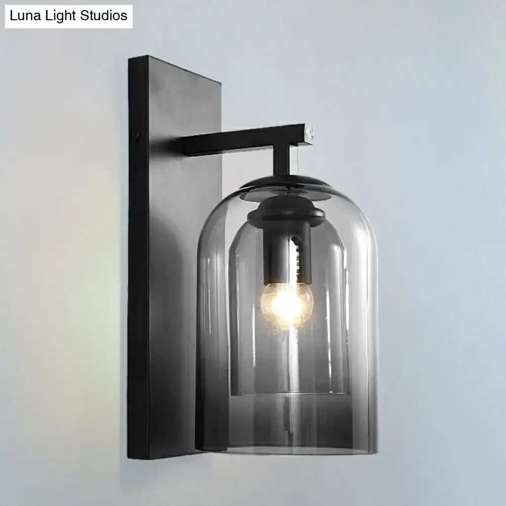 Black metal wall lamp with a smoked glass dome and exposed bulb designed as a Nordic bedroom sconce