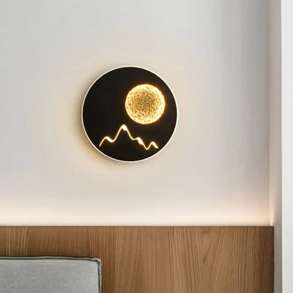 Nordic black white grey circular wall light fixture with illuminated golden sphere and stylized mountain design for bedroom
