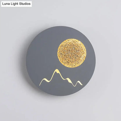 Nordic black white grey wall light featuring a circular matte gray face with gold moon and white mountain silhouettes, fixture height ideal for bedroom